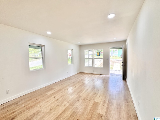 unfurnished room with recessed lighting, light wood-style floors, and baseboards