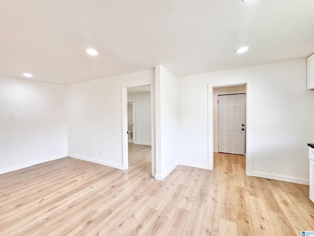 unfurnished room featuring light wood-type flooring, baseboards, and recessed lighting