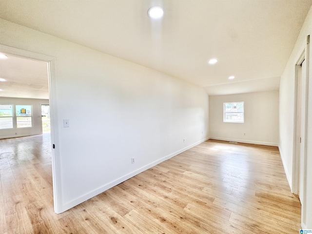 unfurnished bedroom featuring light wood-type flooring, baseboards, and recessed lighting