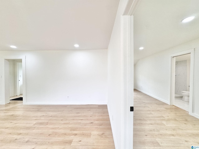 below grade area with recessed lighting, light wood-style flooring, and baseboards