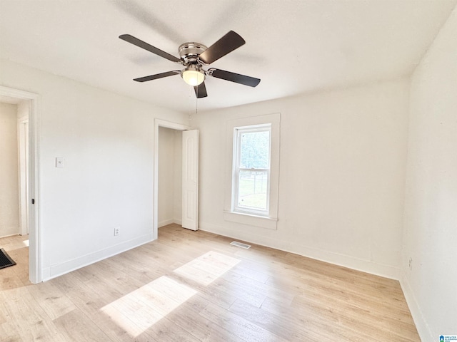 unfurnished bedroom with light wood finished floors, baseboards, and a ceiling fan