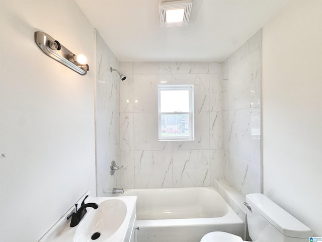 full bathroom featuring toilet, a sink, and washtub / shower combination
