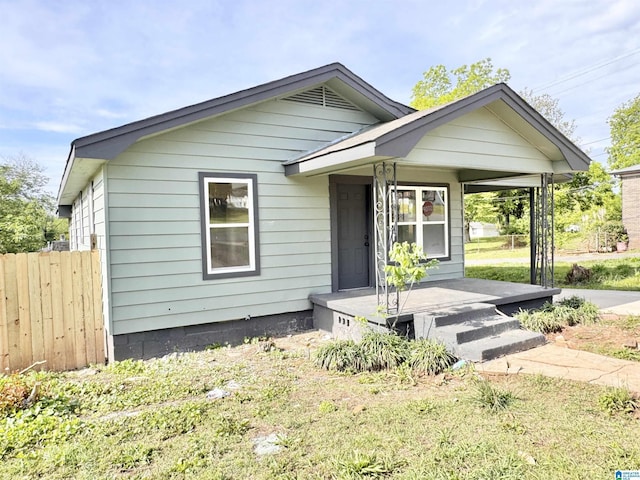 view of front of house with a porch and fence