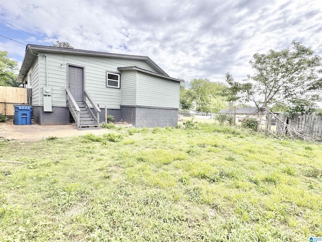 back of property featuring fence and entry steps