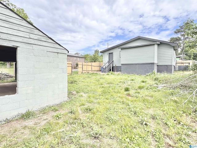 view of yard with fence and entry steps