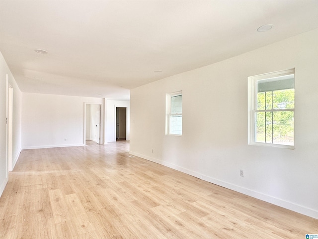 unfurnished room featuring light wood-type flooring and baseboards