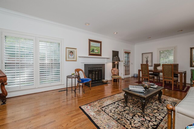 1209 29th St S, Birmingham, AL 35205 - living room with ornamental molding, a fireplace, wood finished floors, and baseboards
