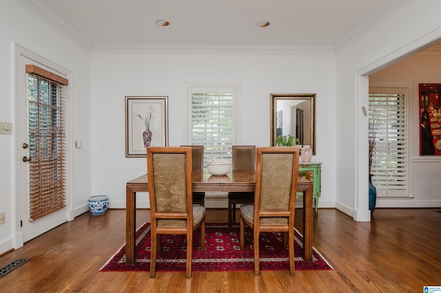 1209 29th St S, Birmingham, AL 35205 - dining room with crown molding, wood finished floors, healthy amount of natural light, and baseboards