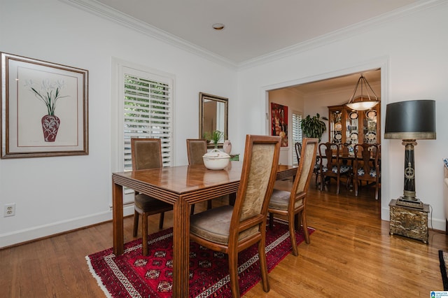 1209 29th St S, Birmingham, AL 35205 - dining room featuring light wood-style floors, crown molding, and baseboards