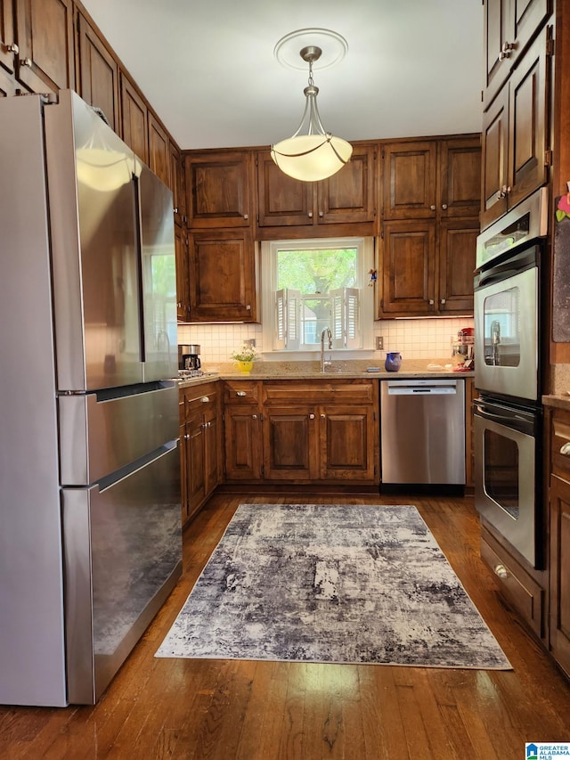 1209 29th St S, Birmingham, AL 35205 - kitchen with stainless steel appliances, tasteful backsplash, and dark wood finished floors