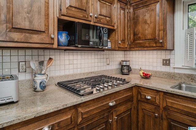1209 29th St S, Birmingham, AL 35205 - kitchen featuring stainless steel gas cooktop, black microwave, tasteful backsplash, and light stone countertops