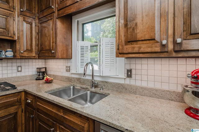 1209 29th St S, Birmingham, AL 35205 - kitchen featuring a sink, decorative backsplash, and light stone counters