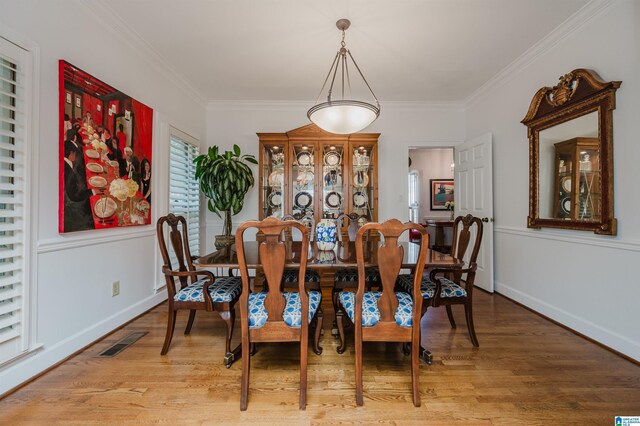 1209 29th St S, Birmingham, AL 35205 - dining space featuring crown molding, light wood-style floors, and baseboards
