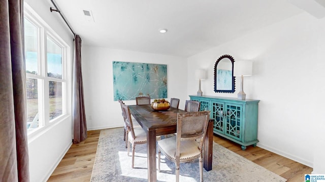 dining area featuring light wood-style flooring, baseboards, and recessed lighting