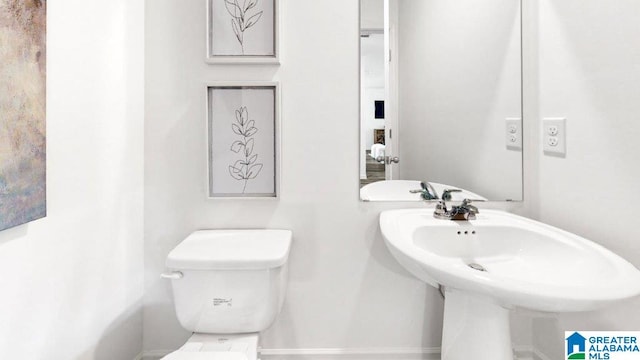 half bathroom featuring toilet