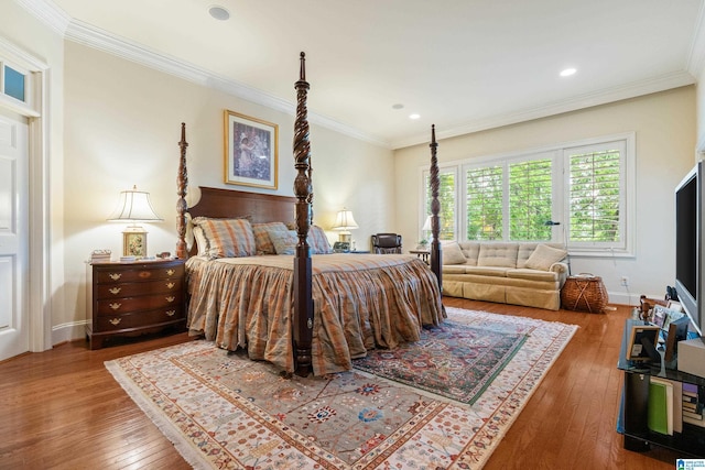 bedroom featuring hardwood / wood-style flooring, ornamental molding, recessed lighting, and baseboards