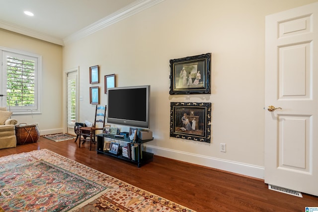 living area with wood finished floors, crown molding, baseboards, and recessed lighting
