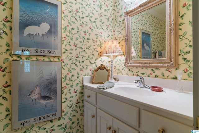 bathroom with wallpapered walls and vanity