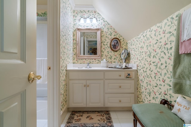 bathroom featuring wallpapered walls, lofted ceiling, vanity, and tile patterned floors