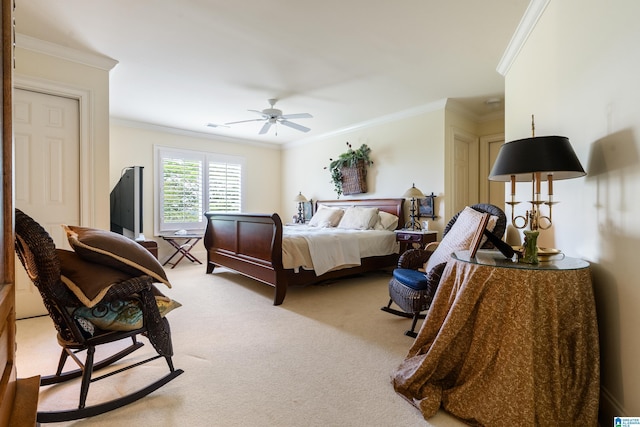 carpeted bedroom with ornamental molding and a ceiling fan