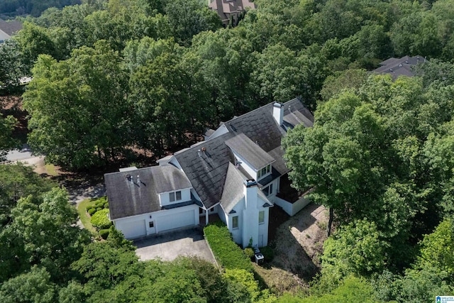 aerial view of property and surrounding area featuring a forest