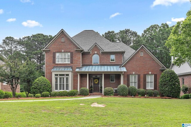 263 Highland Park Dr, Birmingham, AL 35242 - traditional-style house featuring brick siding, a front lawn, a standing seam roof, and roof with shingles
