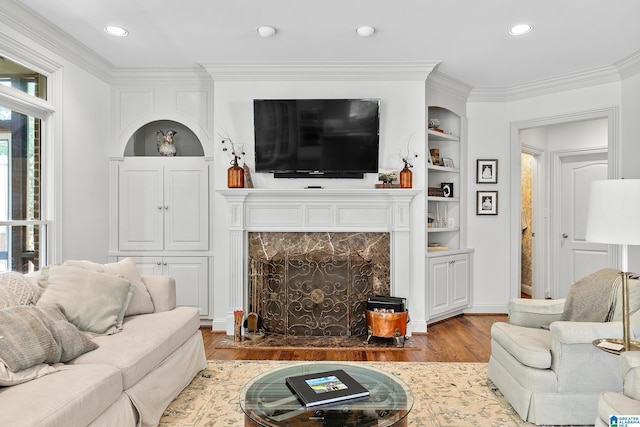 263 Highland Park Dr, Birmingham, AL 35242 - living area with wood finished floors, a high end fireplace, crown molding, built in features, and recessed lighting