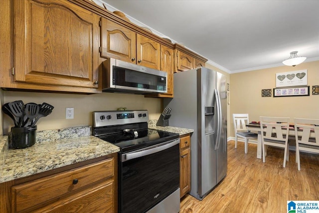 110 Drexal Dr, Oneonta, AL 35121 - kitchen featuring stainless steel appliances, ornamental molding, brown cabinetry, light wood-style floors, and light stone counters