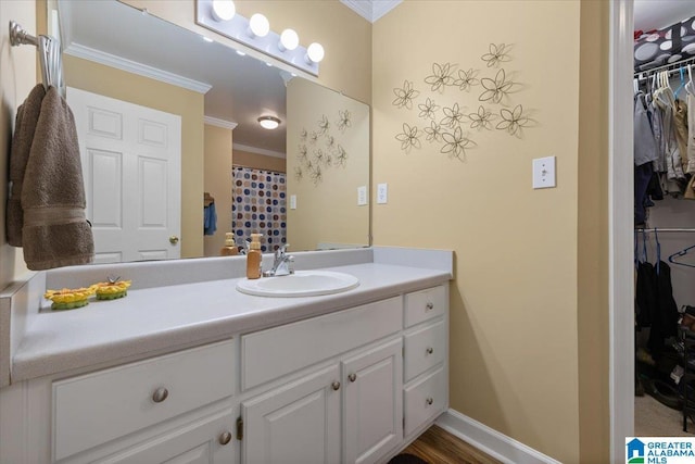 110 Drexal Dr, Oneonta, AL 35121 - bathroom featuring ornamental molding, vanity, a walk in closet, and baseboards