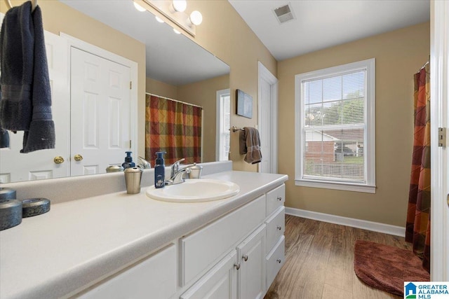 110 Drexal Dr, Oneonta, AL 35121 - full bath with wood finished floors, vanity, baseboards, and curtained shower