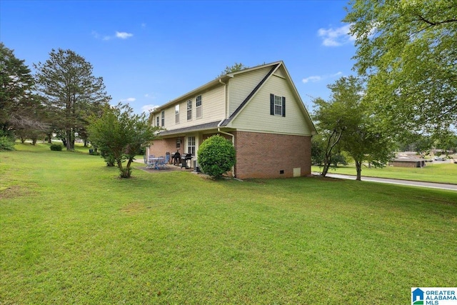 110 Drexal Dr, Oneonta, AL 35121 - view of side of property with a lawn, brick siding, and a patio area
