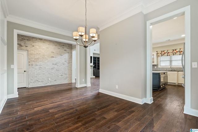 unfurnished dining area featuring brick wall, a chandelier, dark wood-style floors, ornamental molding, and baseboards