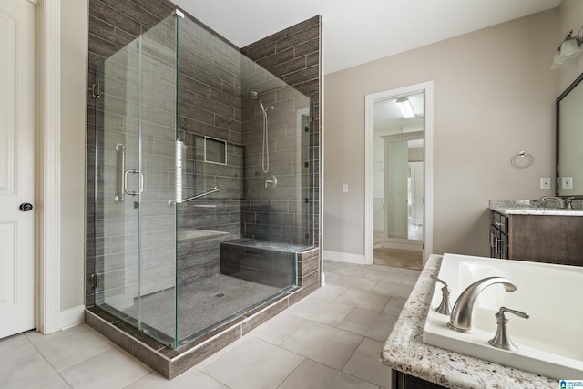 full bathroom with a stall shower, tile patterned flooring, vanity, and a bathtub