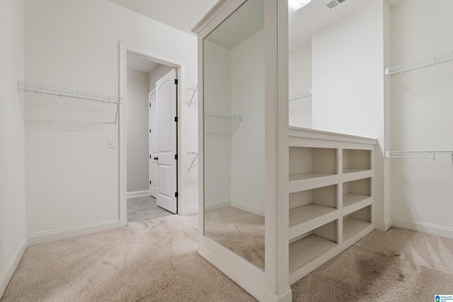 walk in closet featuring carpet flooring