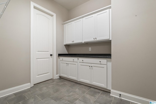 laundry room featuring baseboards