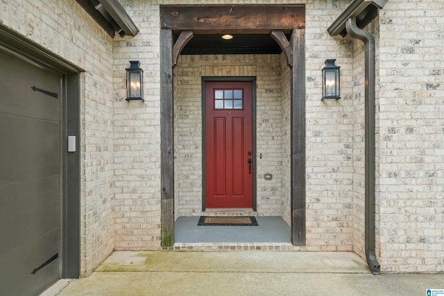 entrance to property featuring brick siding