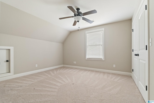 bonus room featuring light colored carpet, baseboards, ceiling fan, and vaulted ceiling