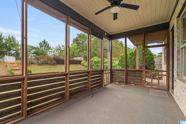unfurnished sunroom with ceiling fan