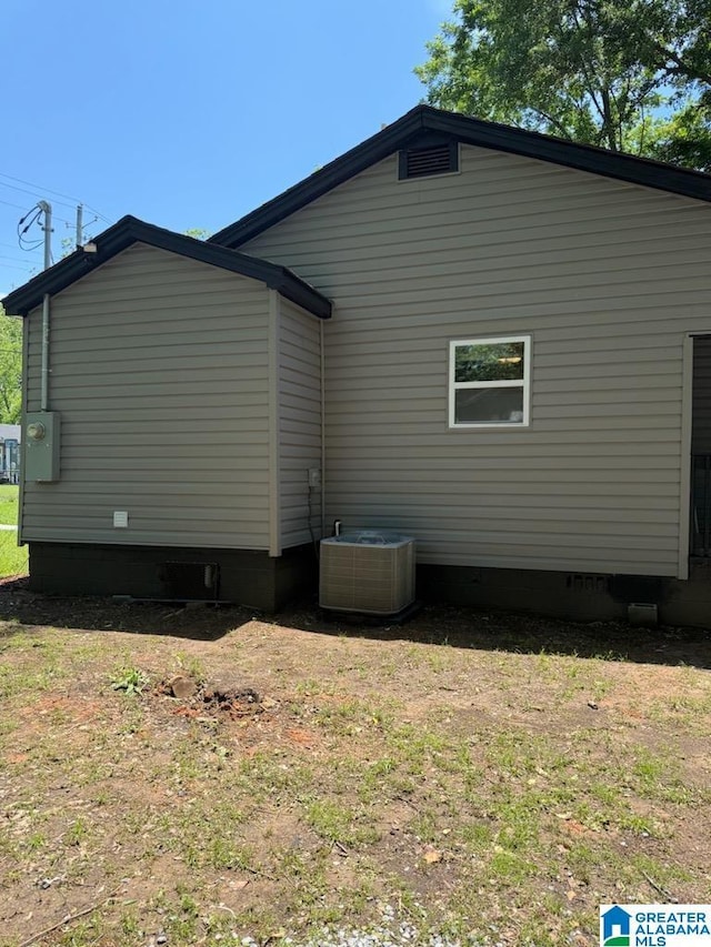 view of property exterior with central air condition unit and crawl space