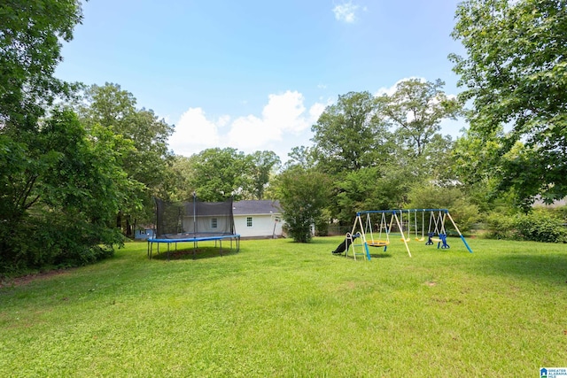 76 Pine Tree Ln, Alexandria, AL 36250 - view of green lawn featuring a trampoline and a playground