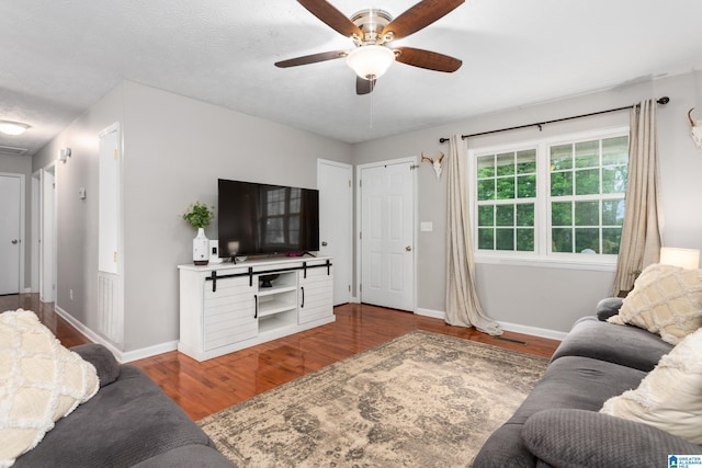 76 Pine Tree Ln, Alexandria, AL 36250 - living area with wood finished floors, a ceiling fan, and baseboards