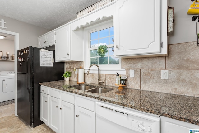 76 Pine Tree Ln, Alexandria, AL 36250 - kitchen with white dishwasher, washer / clothes dryer, a sink, white cabinetry, and dark stone counters