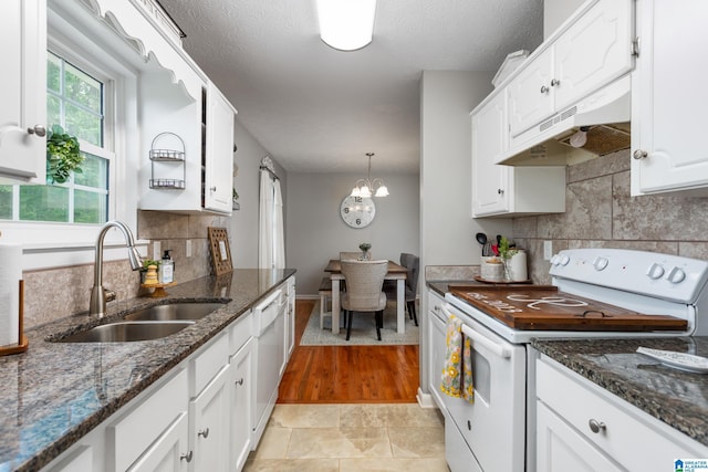 76 Pine Tree Ln, Alexandria, AL 36250 - kitchen with white appliances, a sink, under cabinet range hood, white cabinets, and backsplash