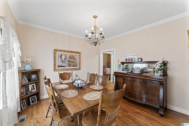 13688 Remlap Dr, Remlap, AL 35133 - dining space featuring a chandelier, ornamental molding, wood finished floors, and baseboards