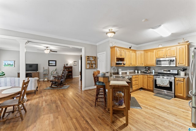 13688 Remlap Dr, Remlap, AL 35133 - kitchen with stainless steel appliances, a sink, light wood-style flooring, a ceiling fan, and ornamental molding