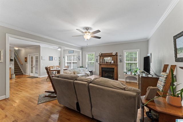 13688 Remlap Dr, Remlap, AL 35133 - living room featuring a fireplace, a ceiling fan, light wood-type flooring, baseboards, and crown molding