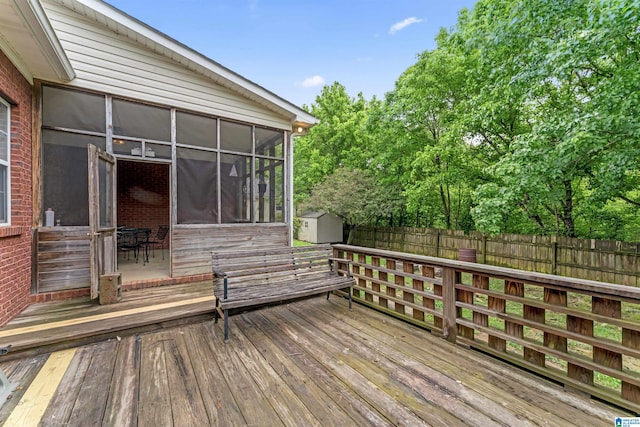13688 Remlap Dr, Remlap, AL 35133 - deck with a sunroom, a fenced backyard, a shed, and an outbuilding