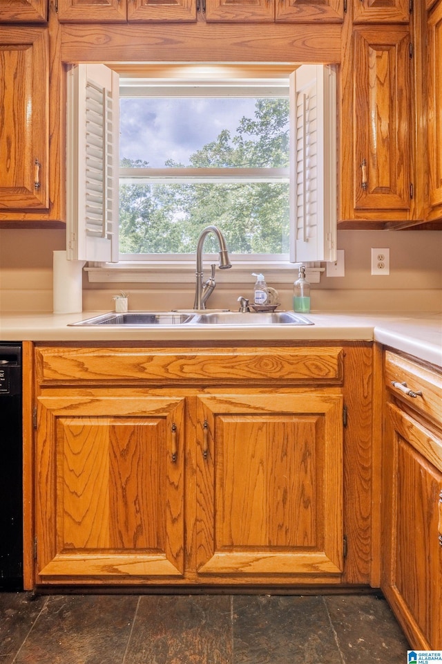 994 Comanche Trl, Anniston, AL 36206 - kitchen with a sink, light countertops, brown cabinets, and dishwasher