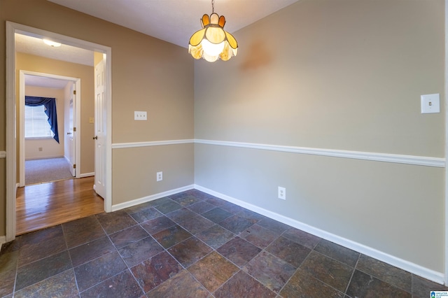 994 Comanche Trl, Anniston, AL 36206 - spare room with baseboards and stone tile floors