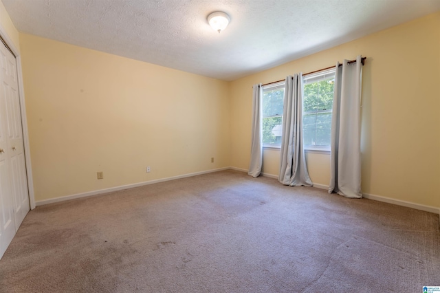 994 Comanche Trl, Anniston, AL 36206 - empty room with carpet flooring, baseboards, and a textured ceiling